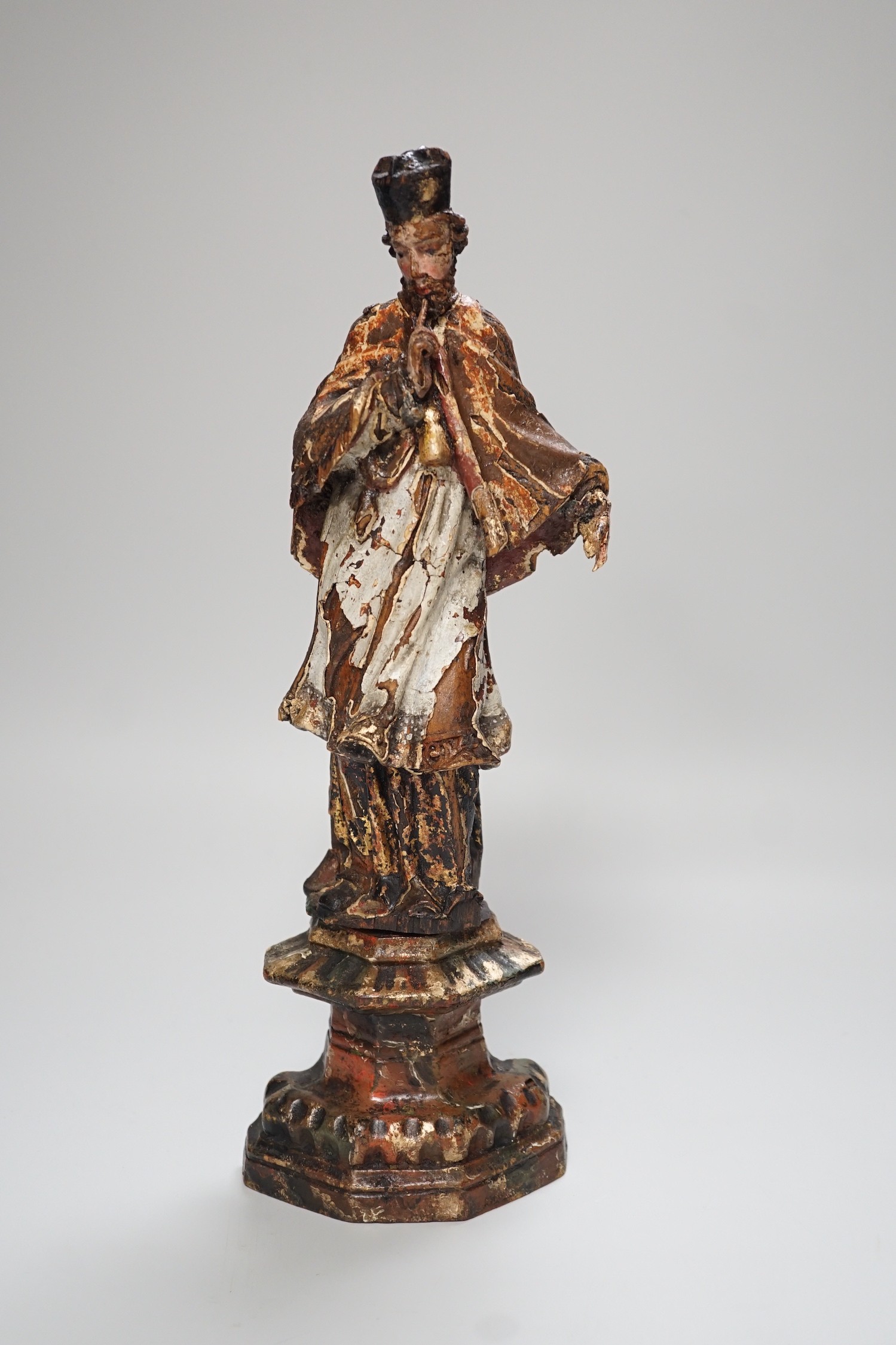 An 18th/19th century Continental carved wooden polychrome figure of saint, 33cms high